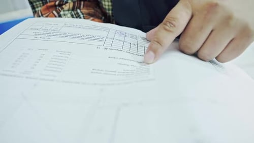 Construction Worker Reading Documents Indoors