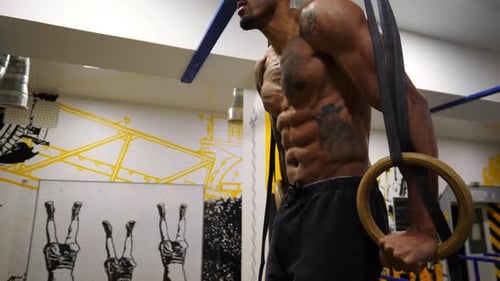 Strong African Athlete Doing Push Ups on Gymnastic Rings at Gym Muscular Afro American Sportsman