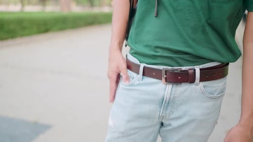 Stylish Person with Hand in Pocket on Sidewalk