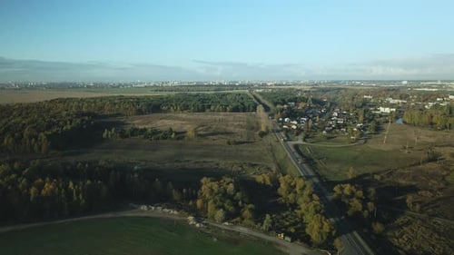 Agricultural fields. On the horizon you can see the settlement and the highway.