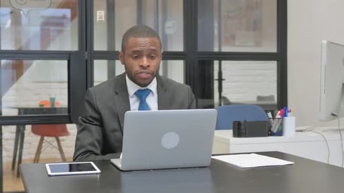 Man on Video Call at Office Desk