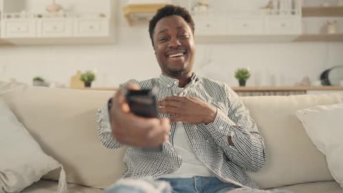 Happy Adult Man Smiling on Cream Colored Couch