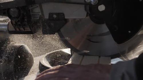 A Circular Saw Cuts a Wooden Board