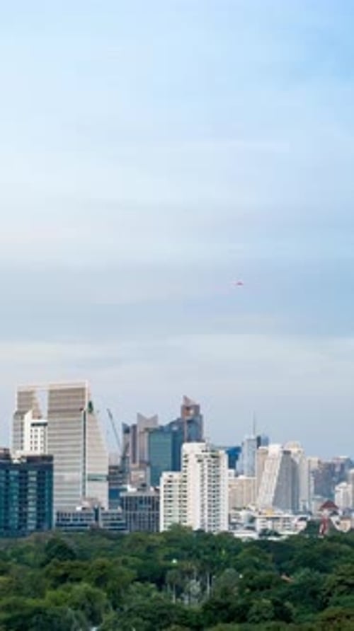 Bangkok cityscape time lapse transitioning from daytime to night with modern skyline.