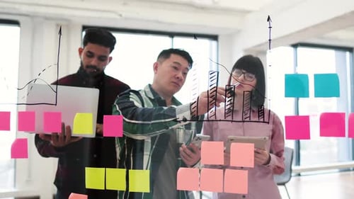 Diverse Team Collaborating on Data Analysis in Office