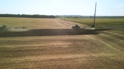 Tractors plowing the field in Ukraine