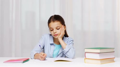 Education, People, Children And Learning Concept - Girl Hand Writing Math Task To Notepad At School