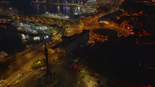 High Angle View of Historic Building and Large Roundabout in Night City Tilt Up Reveal Sea Coast