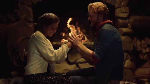 Couple Playing Patty Cake Game by Cozy Fireplace