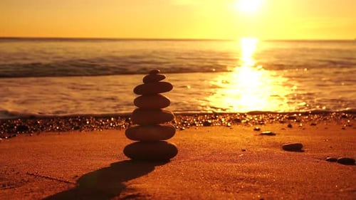Balanced Rock Pyramid on Pebbles Beach Sunny Day and Clear Sky at Sunset