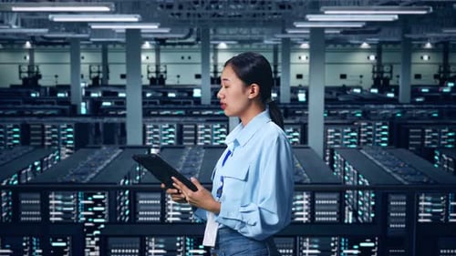 Side View Of Asian Business Woman Using Tablet An Looking Around In Data Center