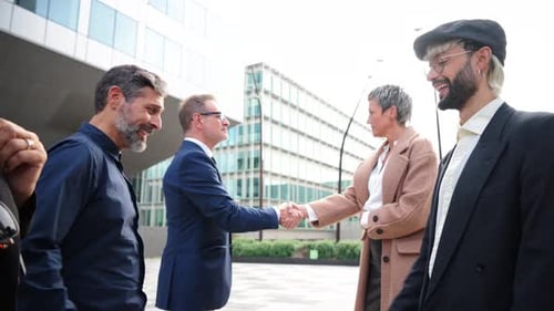 A Group of Business People Shaking Hands in a Work Corporate Meeting to Formalize a Contract with