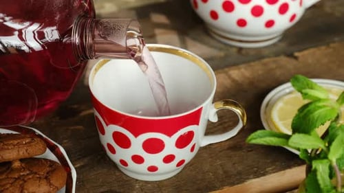 Tea Time Pouring Hot Red Hibiscus Tea Into Mug