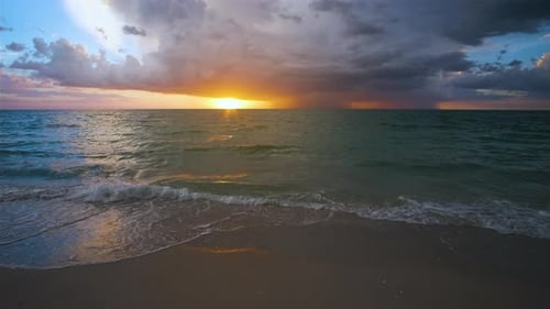Ocean Landscape with Thunderstorm Clouds Over Soft Evening Sea Water Waves Crushing on Sandy Beach