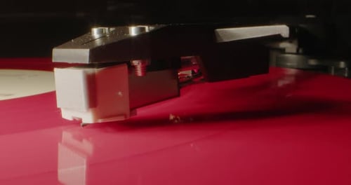 Vinyl Record Player Needle on Red Record