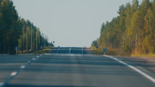 Asphalt road with cars. Camera moves along the road with moving cars