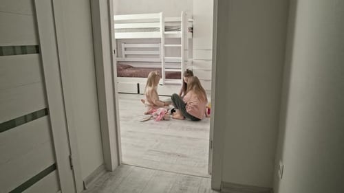 Three Girls Playing Together in Bright Bedroom