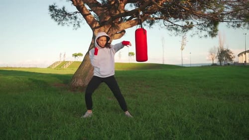 Woman Boxing Outdoors in Park