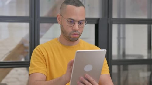 Portrait of Mixed Race Man Using Digital Tablet