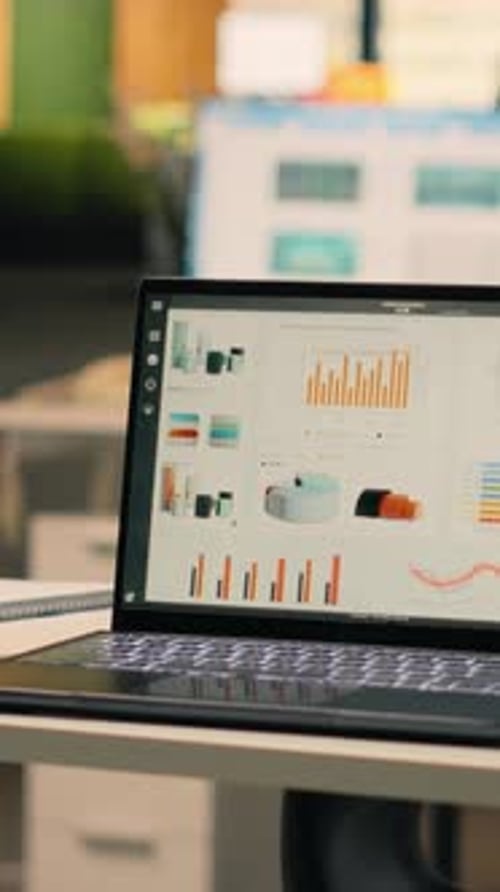 Vertical Video Company Data Reports Running on Laptop in Empty Business Office