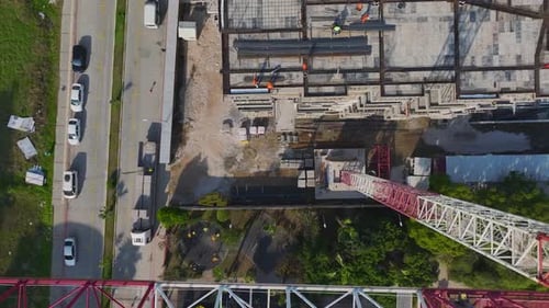 Aerial Video Workers and Cranes on a Construction Site Performing Metal and Material Loading Tasks
