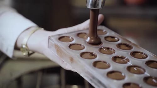 Liquid Chocolate Being Poured into a Mold
