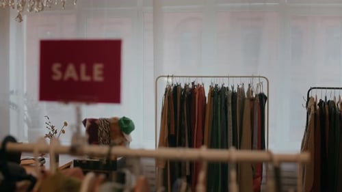 Vintage Clothing Racks with Sale Sign in Cozy Second Hand Shop