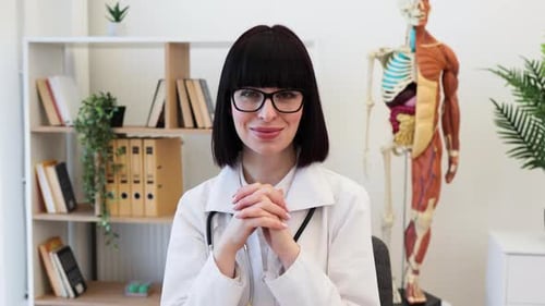 Confident Female Doctor at Office Desk Ready to Assist Patients