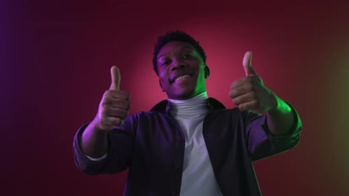 Smiling Man Giving Two Thumbs Up Close-Up