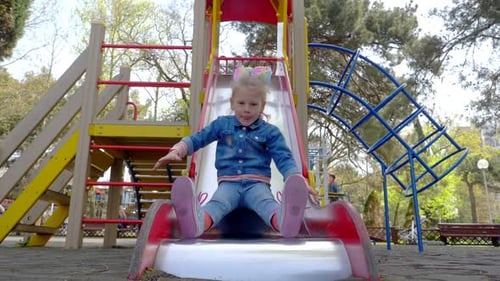 Little girl on the slide at the playground