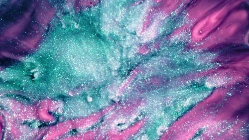 glitter swirl with pink and turquoise liquids mixing in dreamy abstract motion