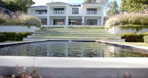 Luxury home with large pool and landscaped garden, showcasing modern architecture, copy space