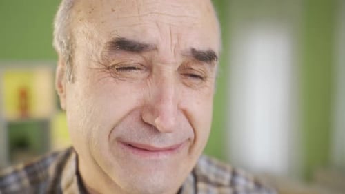 Sad and helpless old man crying, suffering.