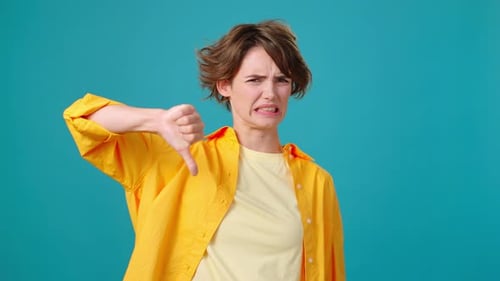 Woman Expressing Dislike with Thumbs Down Gesture