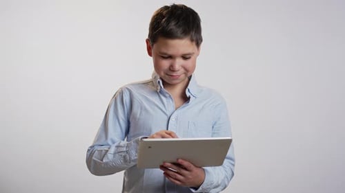 Boy Using Digital Tablet Device Indoors