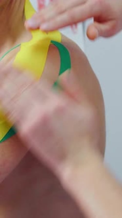A Doctor in Clinic Applies Kinesio Tapes to a Boxer's Injured Shoulder Physiotherapist Makes Kinesio