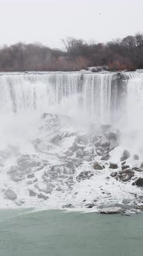 Vertical snow motion shot of Niagara Falls in the winter.