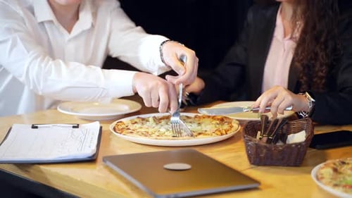 Business pizza corporative with attractive workers. Office celebration.