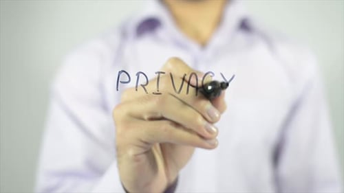 Man Writes 'Privacy' on Transparent Surface