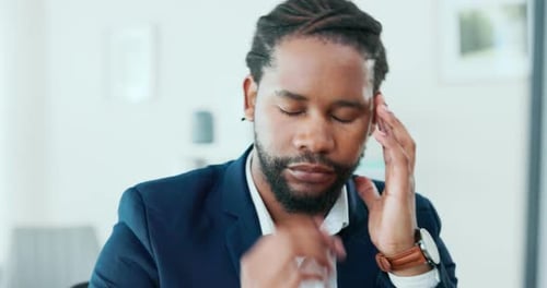 Man In Suit Holding Head Close Up