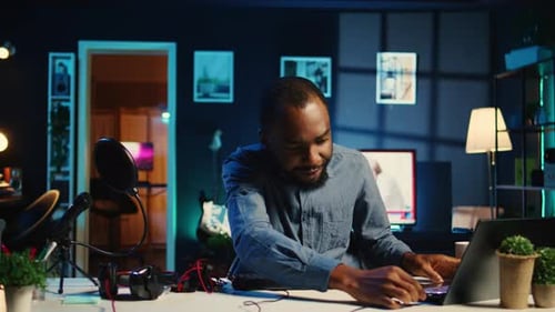 Young Man Presenting Technology at Desk