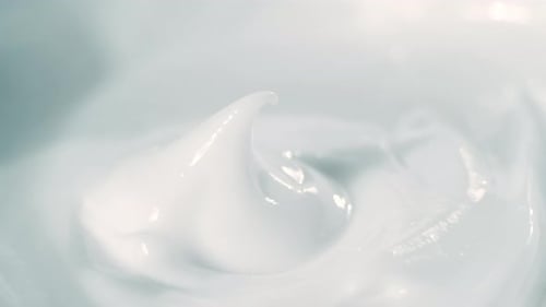 Close Up Shot of Natural Cosmetics Cream with Rotate Effect. Macro White Smooth Facial Cream Texture