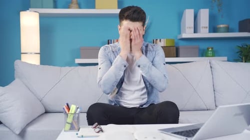 Unhappy, depressed man is thoughtful and not feeling well at home.