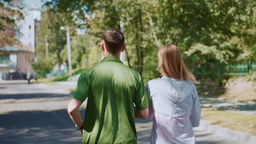 A Couple Jogs Joyfully in a Sunny Park Enjoying Nature and Their Exercise Routine