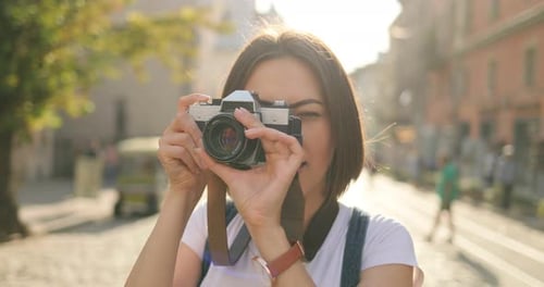 Pretty Girl is Taking Pictures on an Old Film Camera Round View