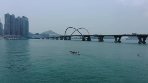 Dragon Boat team rowing to the pace of an onboard Drummer, Aerial view.