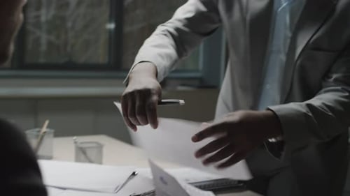 Mature Businessman Reviewing Conflicting Reports in Office