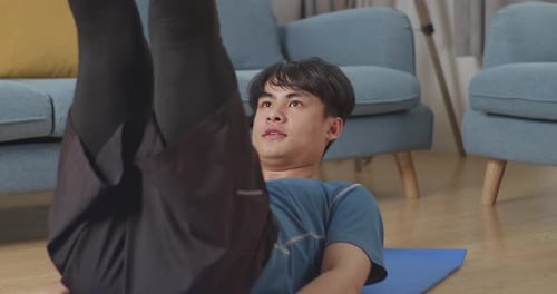 Close Up Of Athletic Shirtless Fit Asian Man In Sports Clothes Is Doing Abdominal Exercises At Home