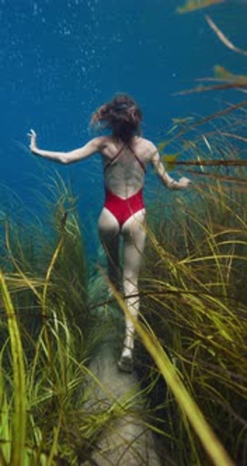 Freediver Woman Posing Underwater in Transparent Lake Freediving in Fresh Water Lake in Indonesia