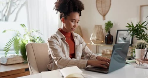 Woman Working on Laptop in Bright Home Office